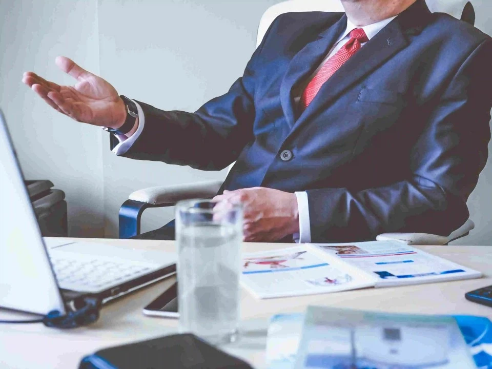 Professional Man in a blue suit and red tie giving advise